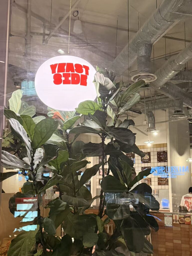 Yeast Side restaurant sign with industrial interior and greenery at Serangoon Gardens