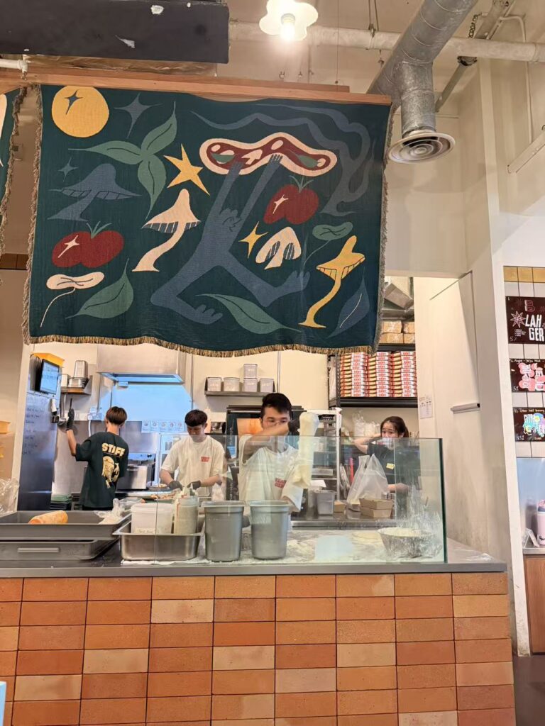 open kitchen at Yeast Side with chefs preparing sourdough pizza
