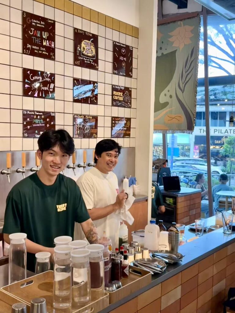 Yeast Side staff preparing drinks behind counter with menu board