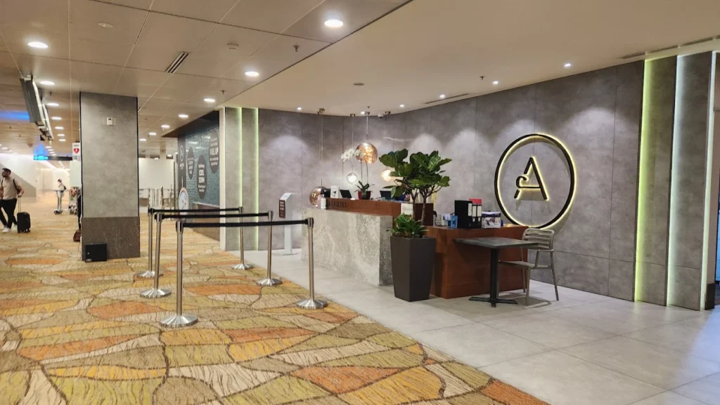 4 Best Hotels Near Changi Airport (Perfect for Layovers & Early Flights) 8 Aerotel Singapore reception area inside Changi Airport Terminal 1 transit zone with modern check-in counter