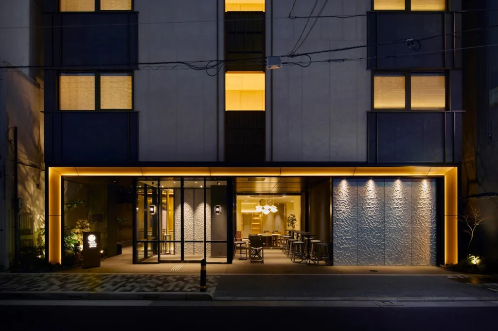 6 Best Boutique Hotels in Ginza Tokyo: Stylish & Unique Stays Guide 10 Agora Tokyo Ginza exterior at night with modern facade, warm lighting, and minimalist boutique hotel entrance in Tokyo