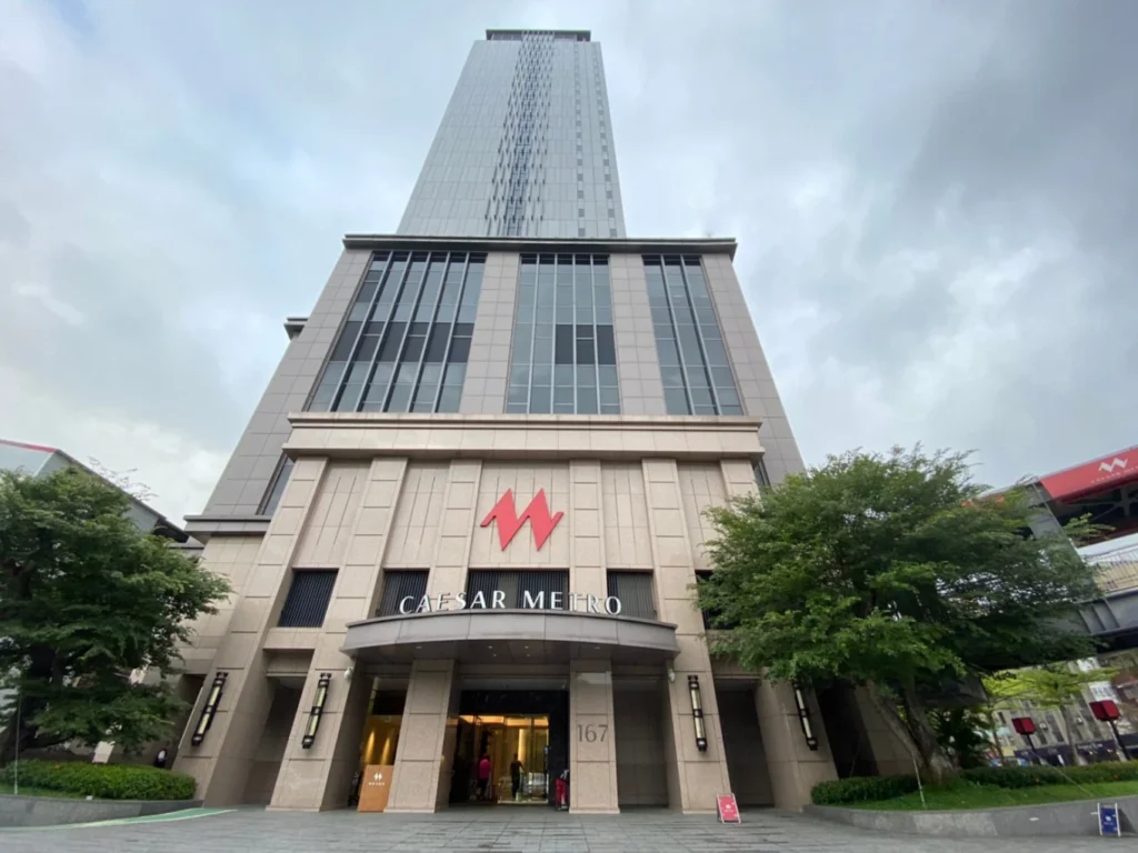 6 Best Muslim Friendly Hotels in Taipei (Halal Hotels Near Ximending & More) 6 Modern high-rise hotel building in Taipei with large glass windows and main entrance at street level