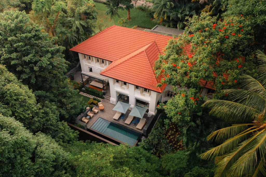 Capella Singapore villa with private pool surrounded by lush tropical greenery and colonial-style architecture in Sentosa