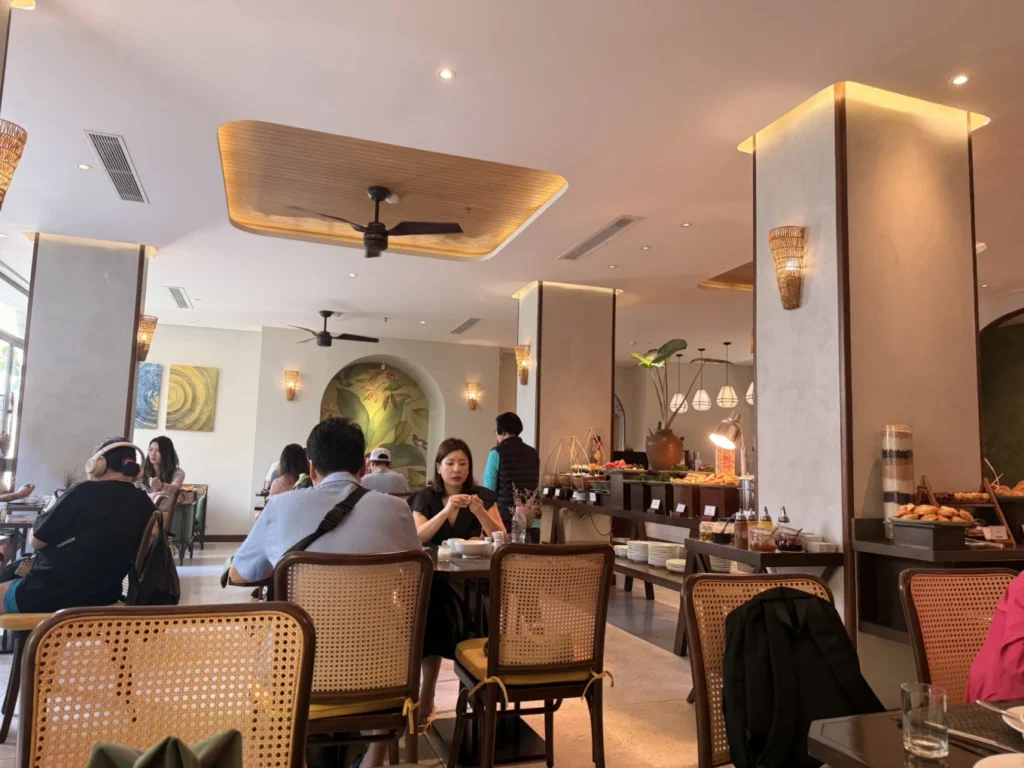 Cozy Danang Boutique Hotel breakfast dining area with guests and buffet setup