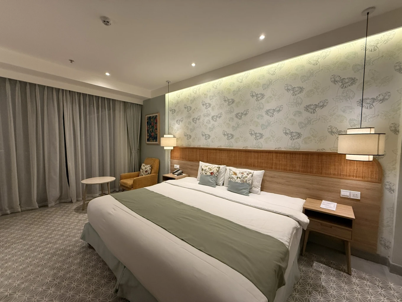 Cozy Danang Boutique Hotel room with king bed, soft lighting and modern minimalist design