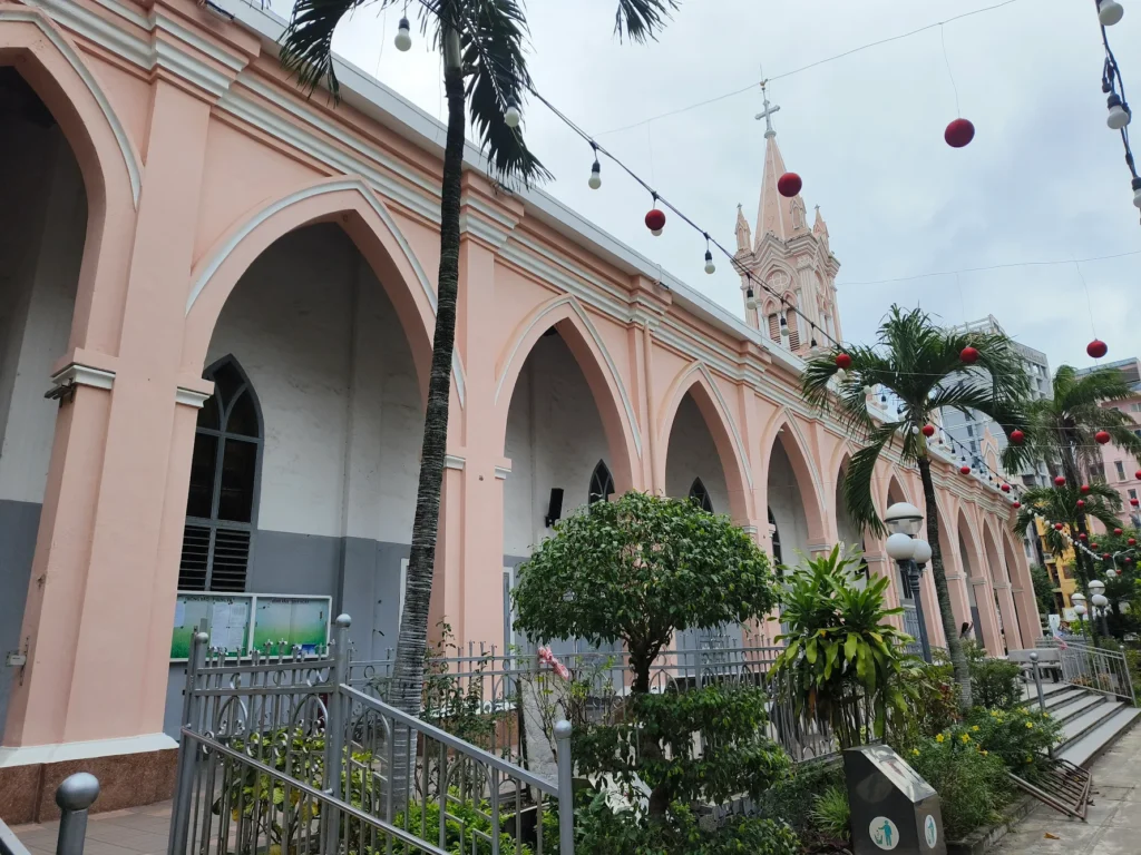side view of Da Nang Cathedral arches walkway pink church Vietnam architecture