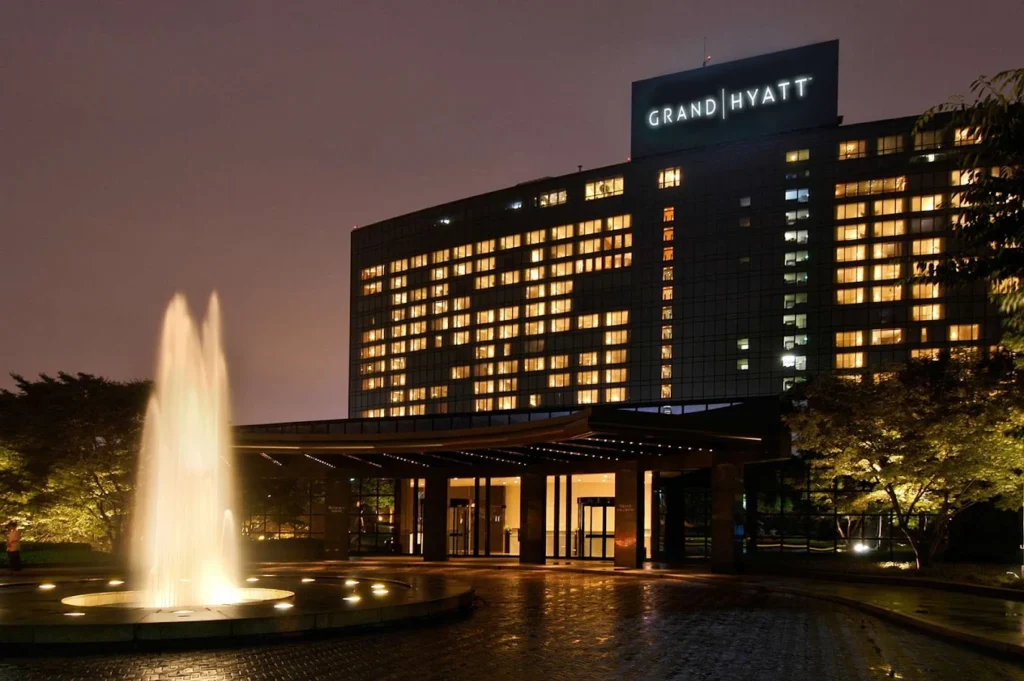Grand Hyatt Seoul hotel exterior at night with illuminated windows and fountain at entrance