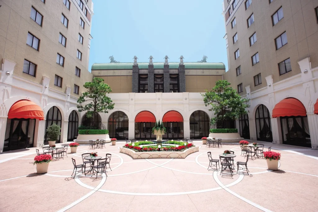 Courtyard of Hotel Okura Tokyo Bay with central fountain, outdoor seating, and elegant European-style architecture