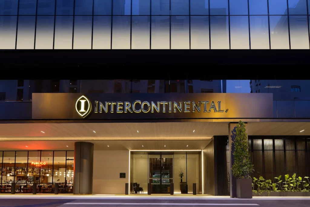InterContinental Singapore Robertson Quay hotel entrance at night with modern exterior and riverside location near Clarke Quay