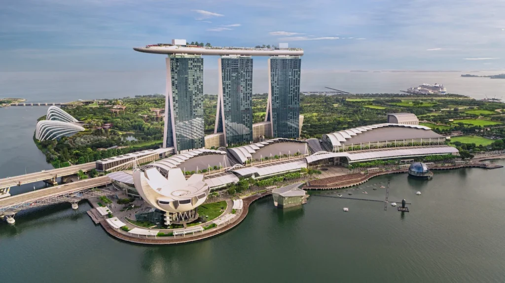 Marina Bay Sands Singapore skyline with infinity pool and Gardens by the Bay aerial view