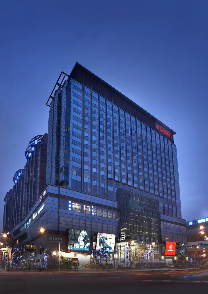 6 Best Muslim Friendly Hotels in Taipei (Halal Hotels Near Ximending & More) 8 Luxury hotel building in Taipei at night with illuminated facade and modern glass exterior