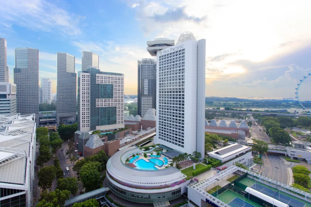 Pan Pacific Singapore hotel with rooftop pool overlooking Marina Bay skyline and Singapore Flyer in central Singapore
