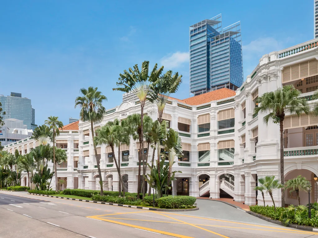 Raffles Singapore exterior colonial architecture with palm trees and historic white facade