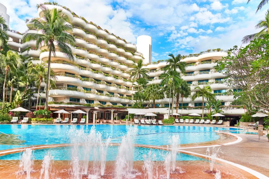 Luxury family-friendly hotel pool at Shangri-La Singapore with tropical landscaping and spacious resort-style design