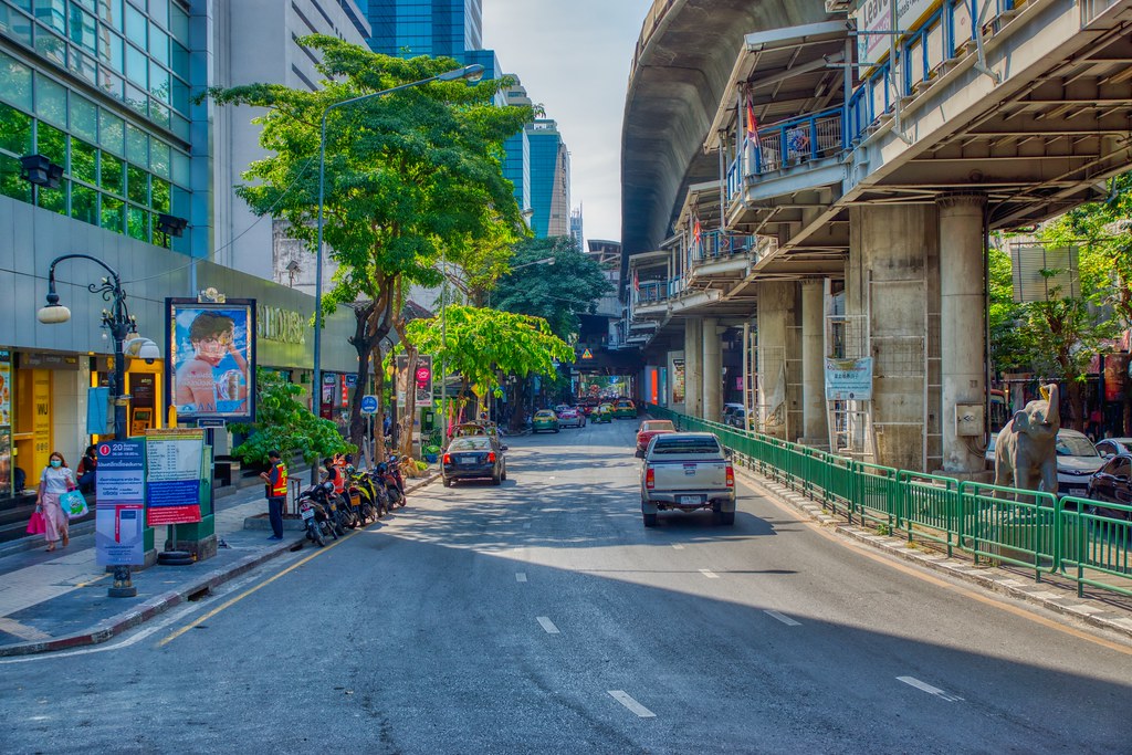 Where to Stay in Bangkok for Muslim Travelers 8 Silom Bangkok street view near BTS line with modern buildings and road traffic, a Muslim-friendly area close to mosques and halal food
