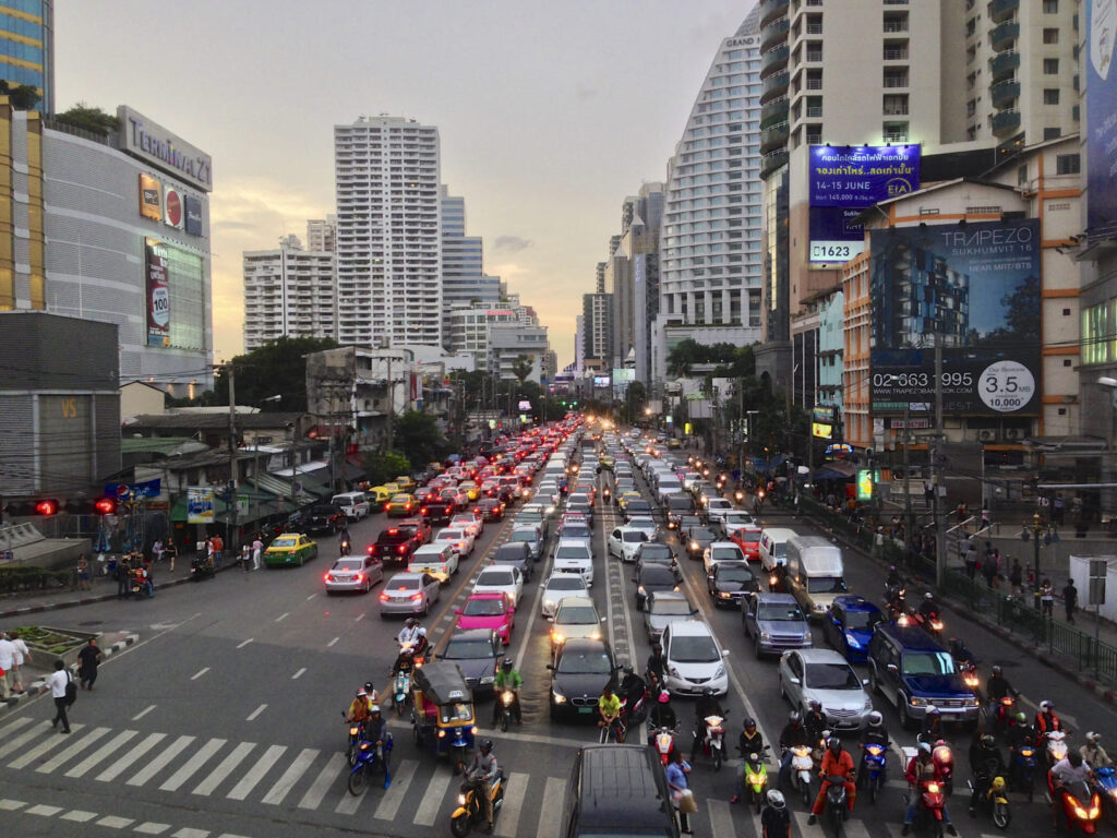 Where to Stay in Bangkok for Muslim Travelers 7 Sukhumvit Bangkok traffic during evening rush hour with city skyline, a central area popular for Muslim travelers staying near BTS and halal restaurants