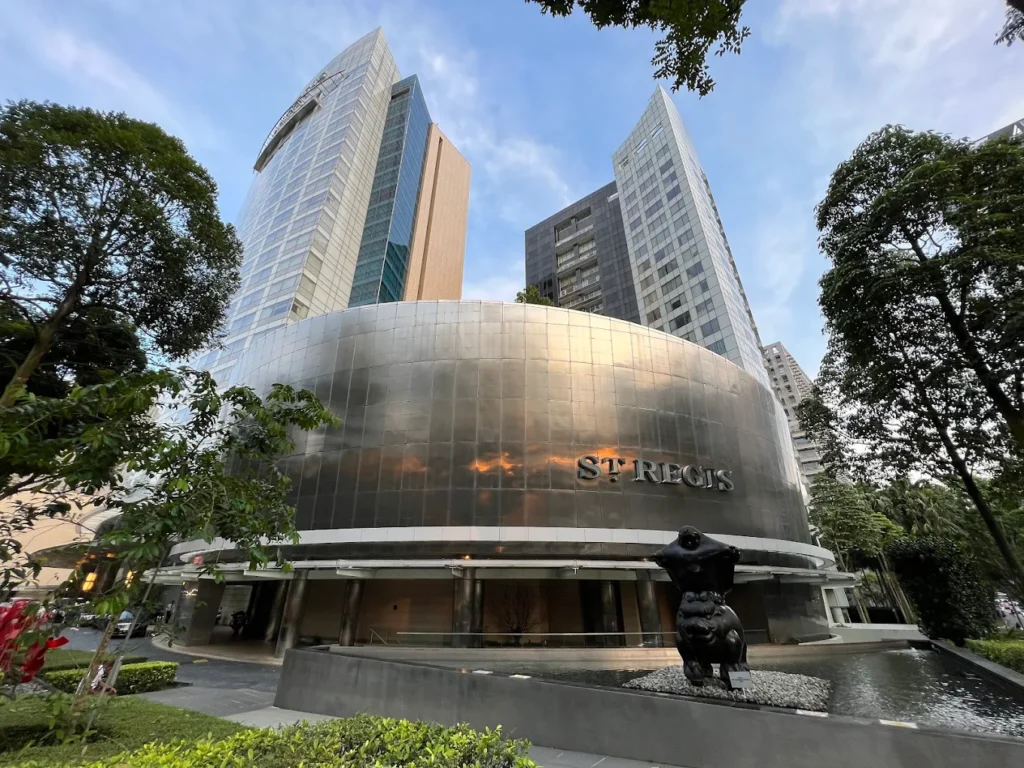 The St. Regis Singapore exterior modern luxury hotel building with reflective facade and entrance fountain