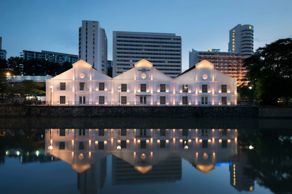 The Warehouse Hotel Singapore exterior at night with river reflection Robertson Quay