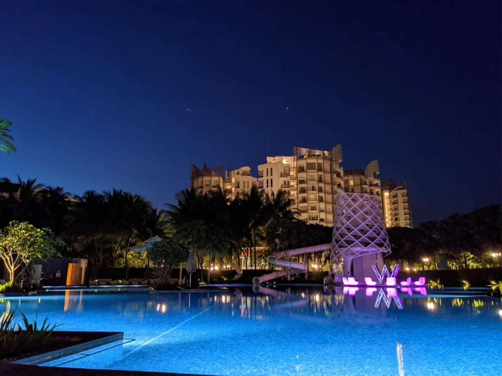 W Singapore Sentosa Cove hotel at night with illuminated resort pool and modern buildings in Sentosa Singapore