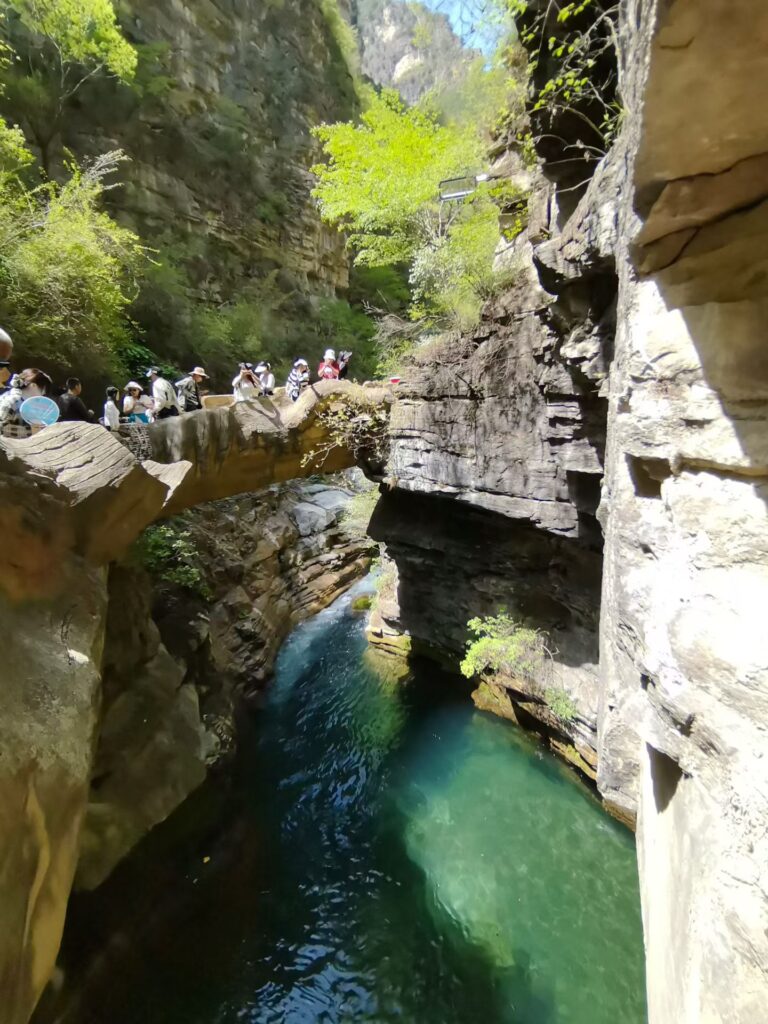 Baquan Gorge Travel Guide: How to Visit Shanxi’s Hidden Canyon Gem 10 Baquan Gorge canyon stream with waterfall and tourists walking along cliffside path