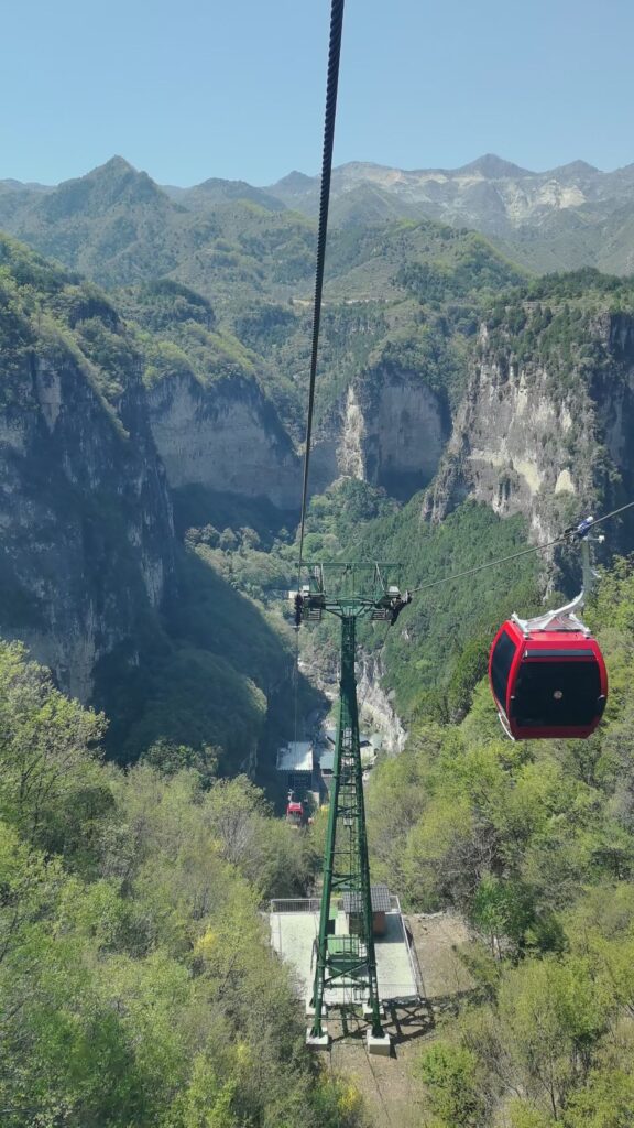 Baquan Gorge Travel Guide: How to Visit Shanxi’s Hidden Canyon Gem 9 Red cable car gondola crossing Baquan Gorge with mountain and canyon views
