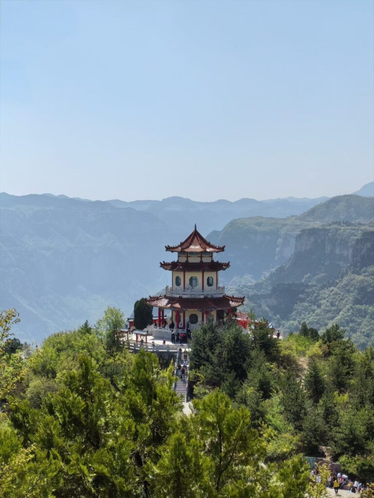 Baquan Gorge Travel Guide: How to Visit Shanxi’s Hidden Canyon Gem 12 Traditional Chinese pavilion overlooking Baquan Gorge mountains and layered canyon landscape in Shanxi