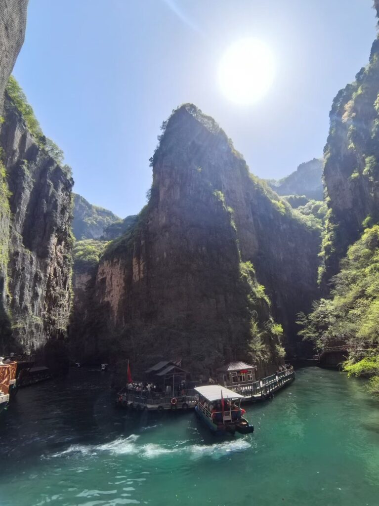 Baquan Gorge Travel Guide: How to Visit Shanxi’s Hidden Canyon Gem 6 Boat ride through narrow canyon river at Baquan Gorge surrounded by steep cliffs and turquoise water