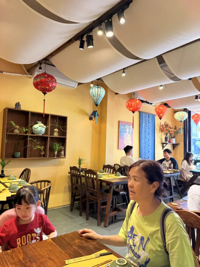 Bếp Lụa Vietnamese Restaurant Review (Da Nang): Worth Skipping Michelin Queues For? 6 Interior of Bếp Lụa restaurant with lanterns and wooden seating in Da Nang
