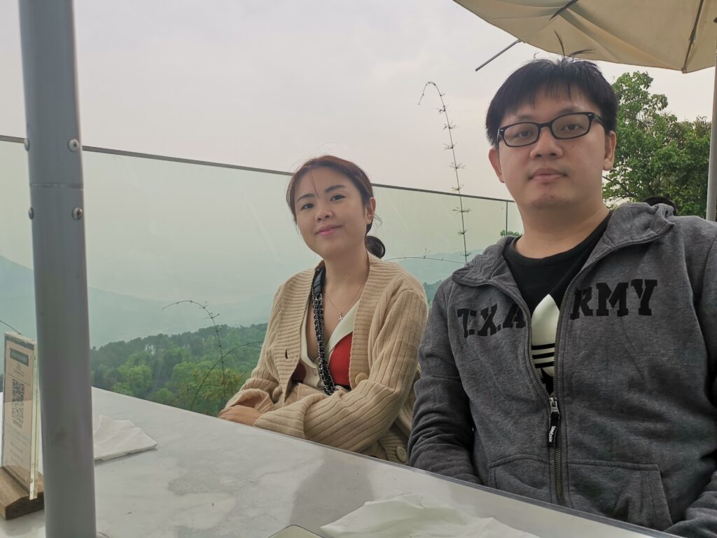 Couple enjoying mountain café view at Nanshan Chongqing with scenic hills and nature backdrop