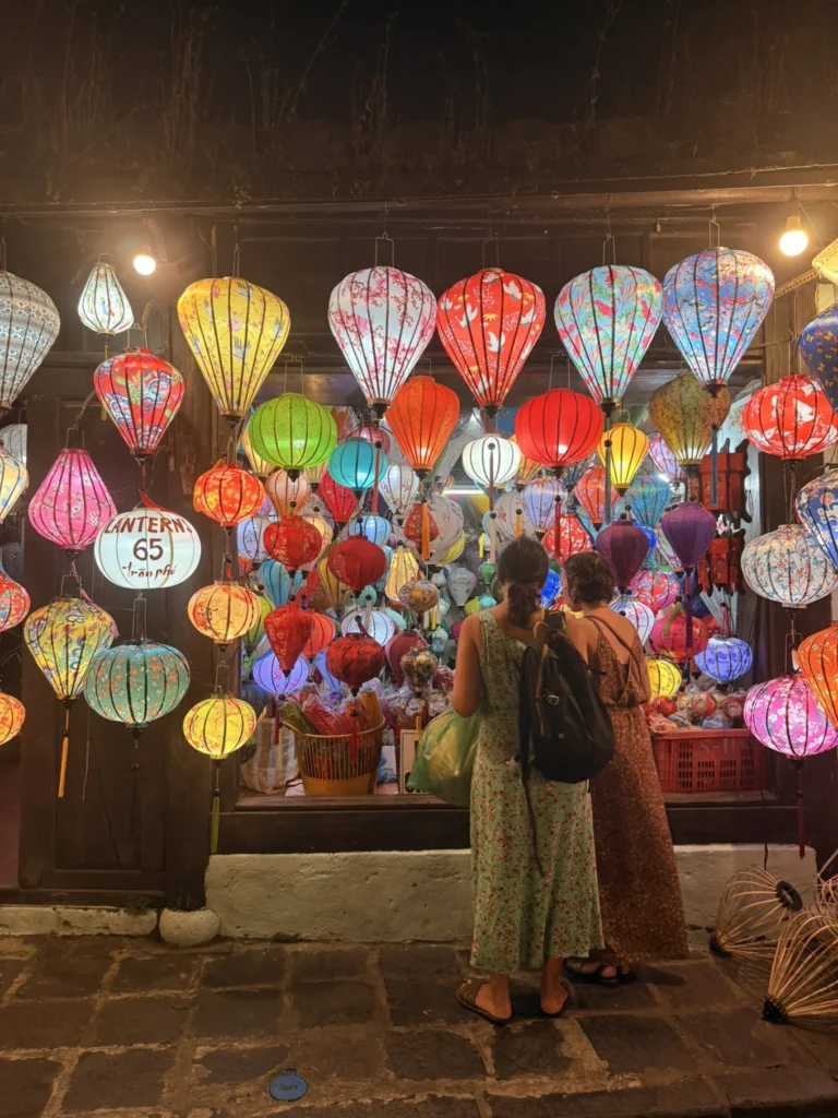 Colorful lantern shop in Hoi An Ancient Town with tourists browsing at night