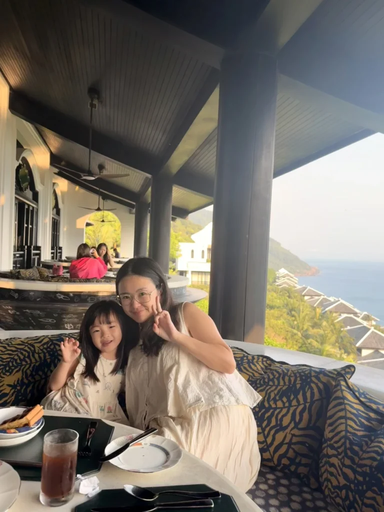 Mother and child enjoying breakfast with ocean view at InterContinental Danang Sun Peninsula Resort