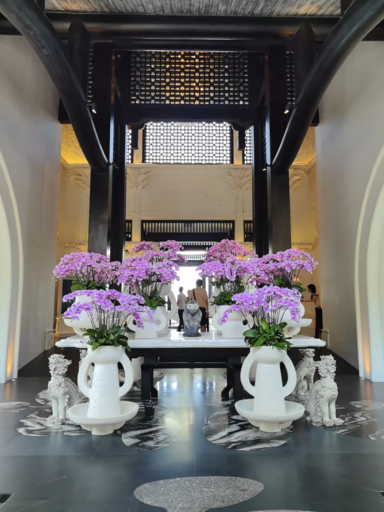 Elegant lobby with orchid arrangements and black white design at InterContinental Danang Sun Peninsula Resort