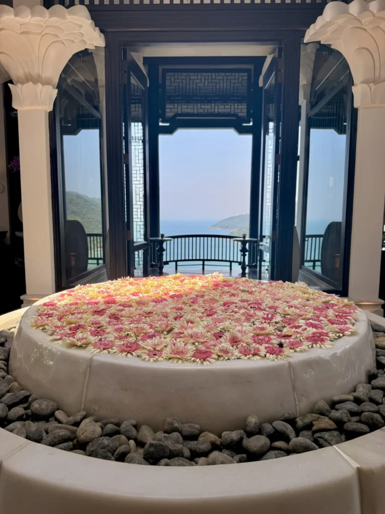 Floral water feature with ocean view framed by architecture at InterContinental Danang Sun Peninsula Resort