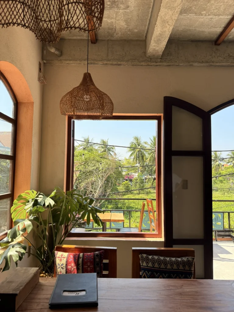 Mate Restaurant and Coffee Hoi An Review: Hidden Café Worth Visiting 6 Mate Restaurant Hoi An interior window seating with natural light and tropical greenery view
