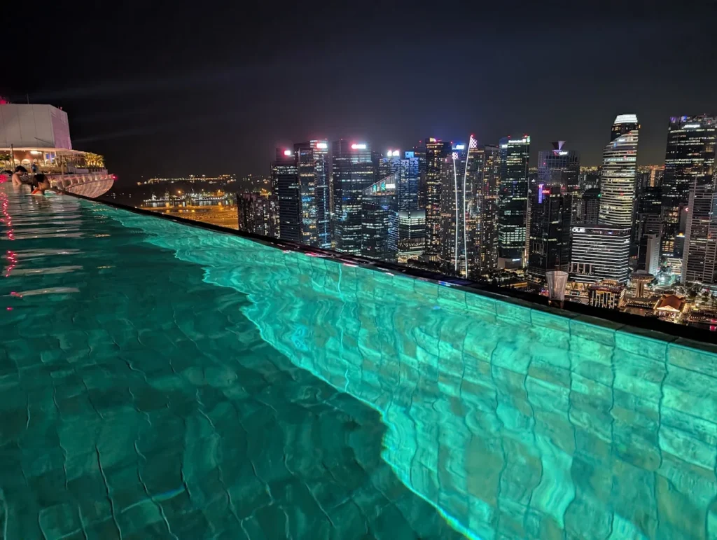 Marina Bay Sands infinity pool at night overlooking Singapore skyline city lights