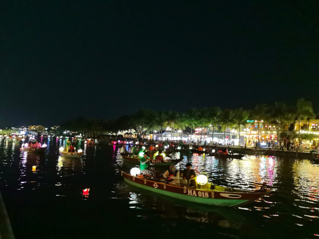 Hoi An lantern boats at night with colorful lights on the river
