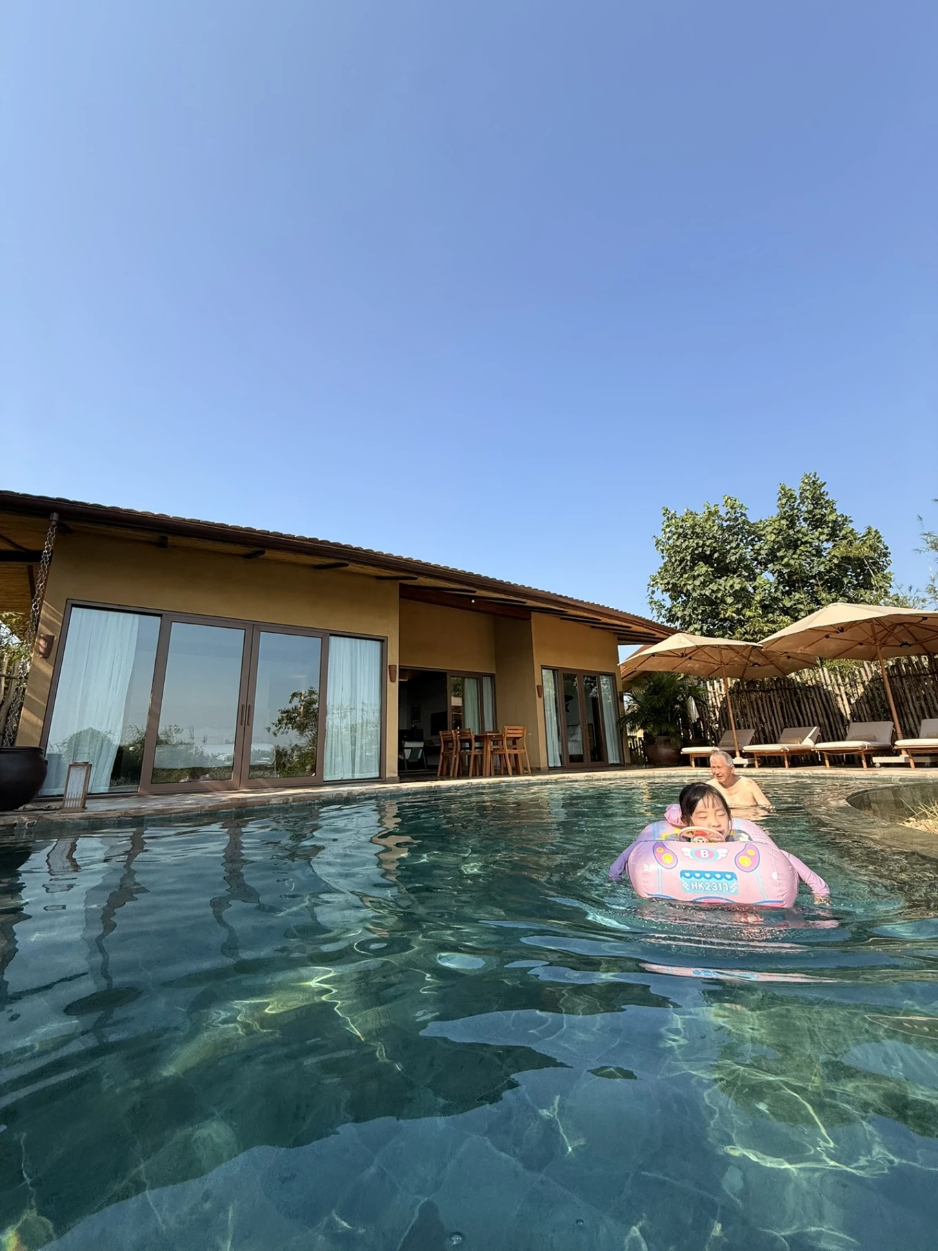 Family enjoying private pool at Namia River Retreat villa in Hoi An