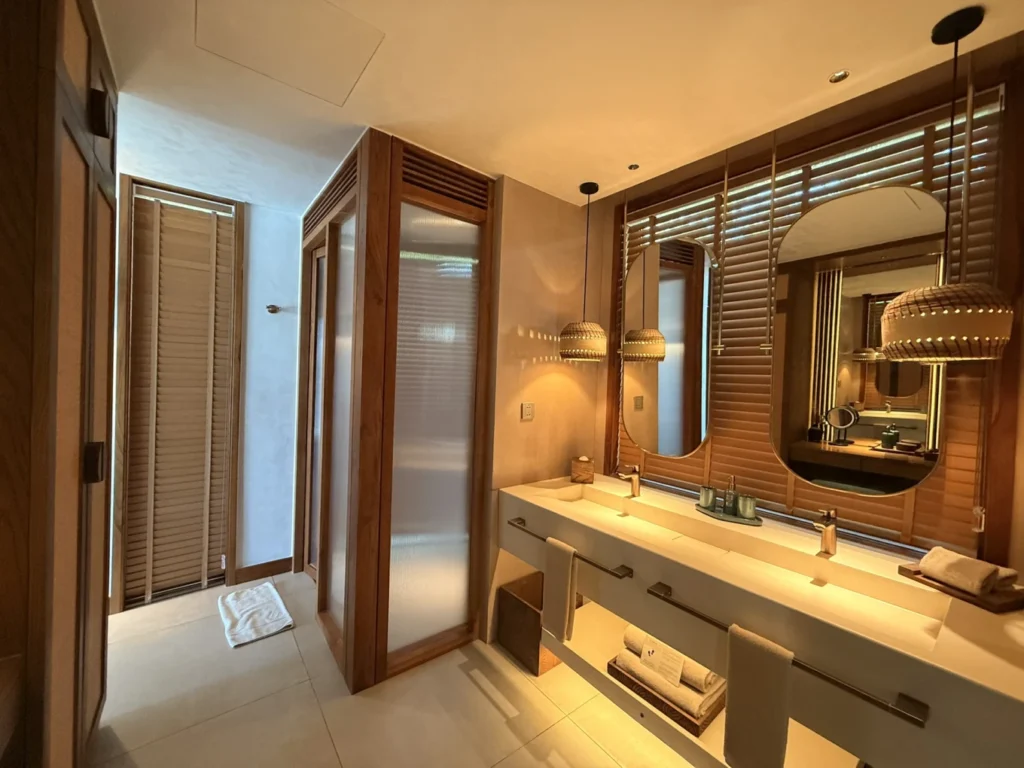 Namia River Retreat bathroom with double sinks and warm lighting design