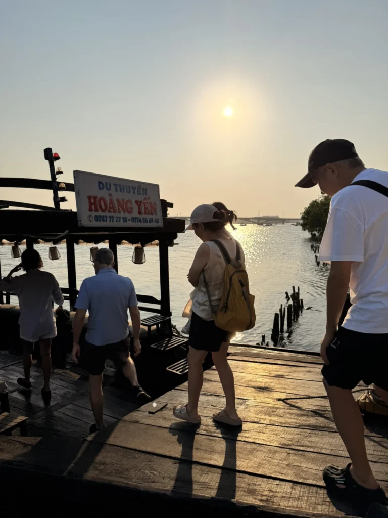 Guests boarding Hoàng Yến boat at sunset along Thu Bon River in Hoi An