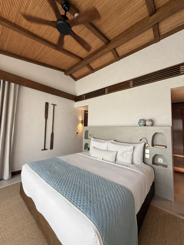 Namia River Retreat bedroom with high ceiling wooden design and king bed