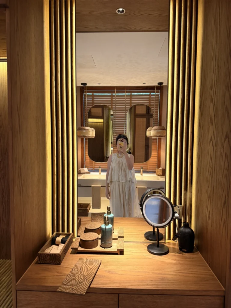 Namia River Retreat vanity mirror area with wooden decor and soft lighting