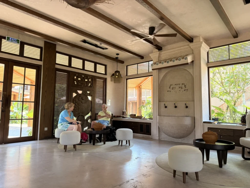 Namia River Retreat spa lounge waiting area with guests relaxing in Hoi An