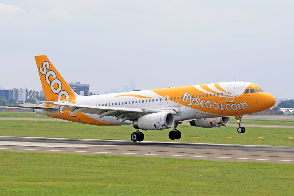 Scoot airplane landing on runway representing budget flights to Japan for cheaper travel