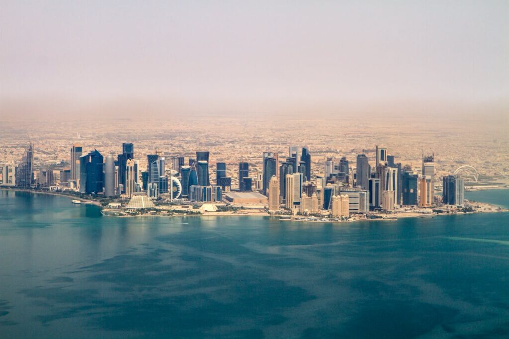 Doha skyline along the الخليج العربي with modern skyscrapers and waterfront cityscape in Qatar