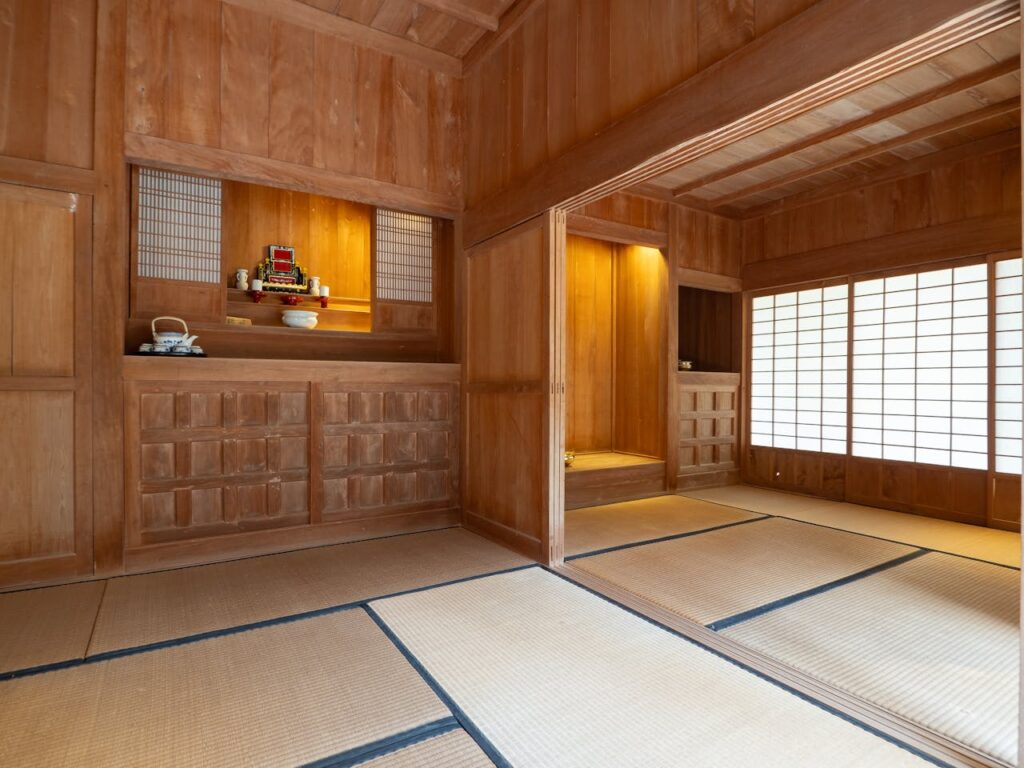 Staying at a Ryokan in Japan With Kids: What to Expect 7 Traditional Japanese tatami room with wooden interiors, sliding shoji doors, and a tokonoma alcove display.