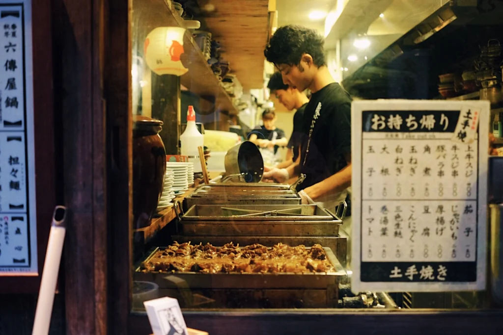 Pontocho Alley Kyoto Guide: Best Time to Visit, Food & What to Expect 8 Japanese street food stall cooking traditional dishes inside small Kyoto restaurant in Pontocho