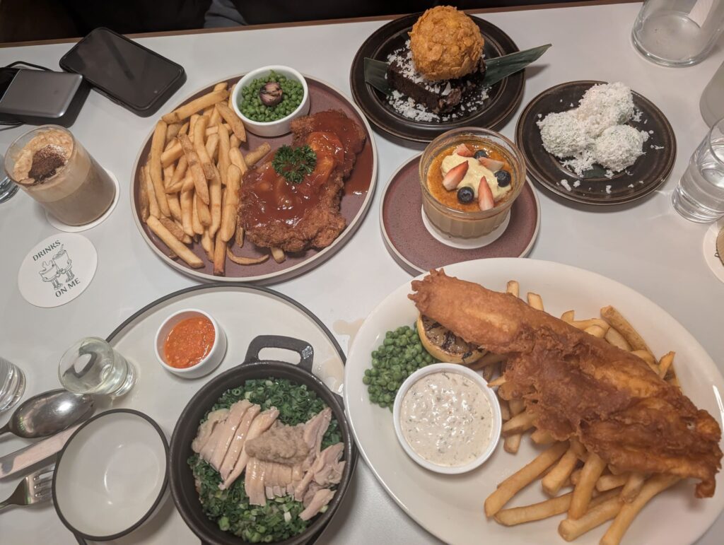 Seng House Review: Big Portions, Mixed Flavours & Must-Try Dish 8 Top view of Seng House meal with fish and chips, pork chop, claypot chicken rice and desserts