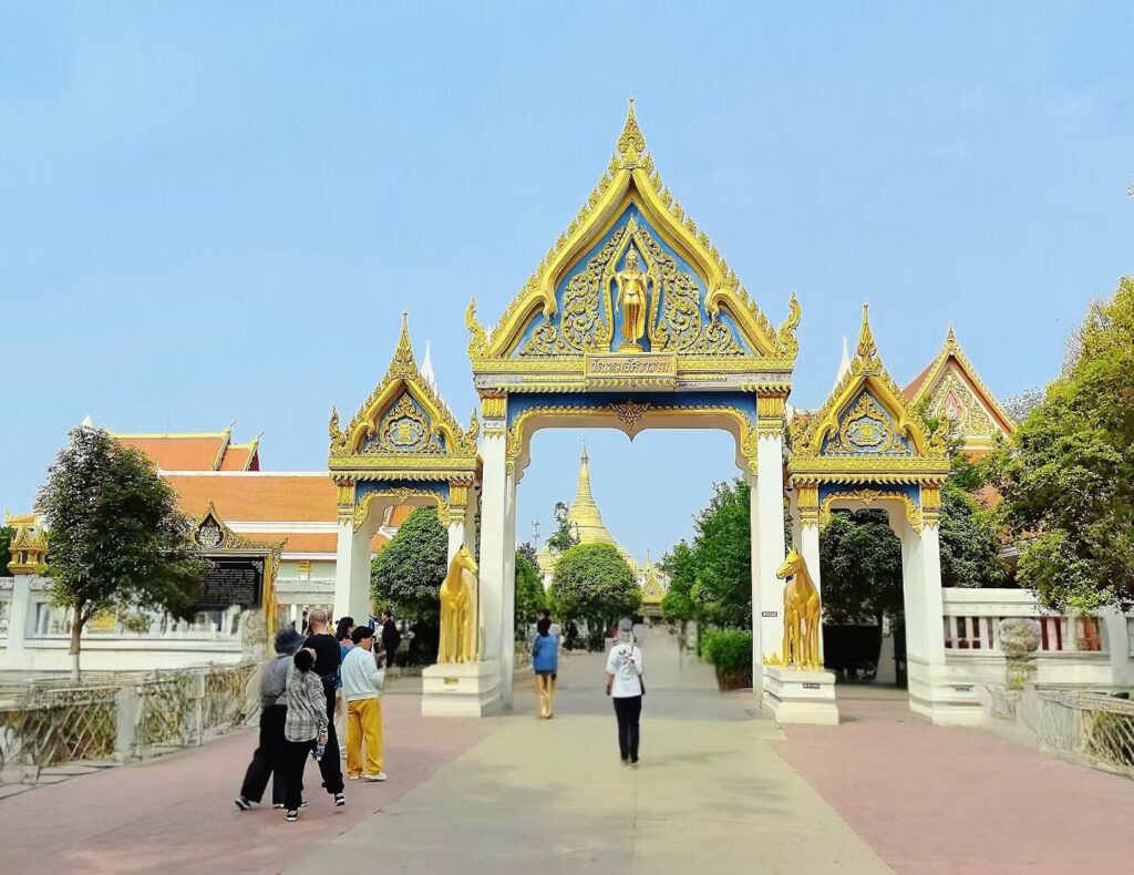 Ornate Thai-style temple gate with golden details at White Horse Temple