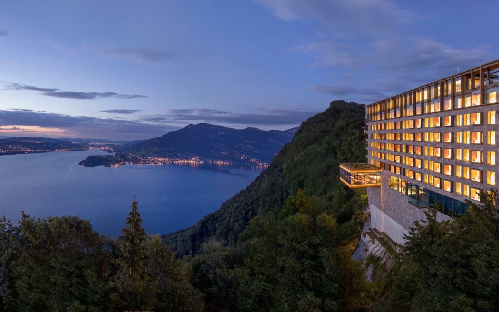 Bürgenstock Hotel & Alpine Spa overlooking Lake Lucerne and the Swiss mountains at dusk