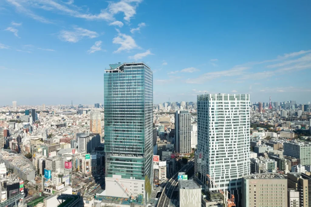 Skyline view of Shibuya Tokyo featuring Cerulean Tower Tokyu Hotel rising above the surrounding city buildings on a clear blue day.